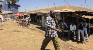 African man walking and talking on mobile phone